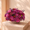 The Purple Rose Arrangement is a beautiful floral design featuring purple roses