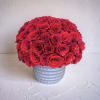 A stunning, sculptural arrangement featuring a dense, dome-shaped formation of premium red