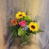 This bright and colorful arrangement brings brighter hues to your recipient's eye.