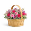 A romantic garden-style basket overflowing with vibrant pink and fuchsia blooms, soft