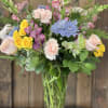 This arrangement has a mix of assorted blooms that evoke a carefree