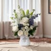 The Heavenly Peace Sympathy Bouquet is a serene and elegant display designed