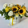 Sunflower and white rose arrangement in a white hatbox with yellow ribbon