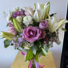 Bouquet of pink roses and white lilies in a glass vase