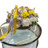 An elegant basket arrangement featuring yellow, lavender, and white flowers-a perfect blend