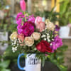 Fresh flowers in coffee mug 