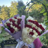 Two bouquets of red and white roses wrapped in pastel paper