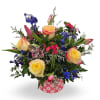 Select this bold and beautiful arrangement featuring vibrant roses, pops of blue