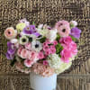 A simple, sweet arrangement of Roses, Spray Roses, Anemones, Tulips, Ranunculus and