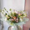 A bouquet made with delicate blooms in various shades of pink, white