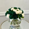 Deep green roses take center stage alongside delicate ivory roses, creating a