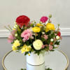 A bright mix of ranunculus, peonies, and seasonal blooms in a modern