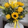 Send a little sunshine with this cheerful yellow floral arrangement, perfect for