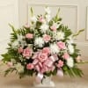 A soft and elegant white and pink floral basket designed to convey