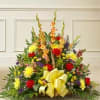A bright and thoughtful sympathy floral basket featuring a cheerful mix of