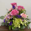 Pink roses and carnations with green hydrangea make for a sweet combination.
