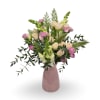 A soft and pretty mix of pastel blooms arranged in pink vase