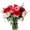 A lush cluster of large red and light-pink roses with delicate blush