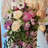 Beautiful, fragrant, Spring bridal bouquet with cascading lilacs, peonies, tulips, anemones, clematis