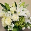 A gorgeous assortment of white, cream, and green premium flowers make for