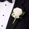This white rose boutonniere is a timeless lapel accessory featuring a single