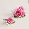 This striking corsage and boutonniere set, featuring bold hot pink blooms, is