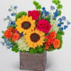 multicolor mix flowers arrangement in a wooden vase 