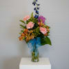 Mixed flowers and colors arranged in a clear vase