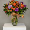 Assorted flowers in shades of purple and orange, with a butterfly touch
