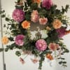 A permanent wreath with plumy faux blooms