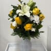 Yellow Vase arrangement with greenery, white lilies, and white chrysanthemum in a