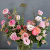 Soft pinks and peachy tones in a ribbed clear glass vase in