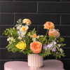 Step into spring with this stunning arrangement, showcasing fresh seasonal blooms in