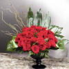 This Beautiful arrangement has Red Roses, curly willow, Leather leaf and green