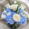 This arrangement has roses, hydrangeas, tulips, and lisianthus. The picture shown above