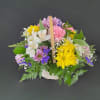 A basket of bright, colorful flowers to pick up anyone's spirits. Includes
