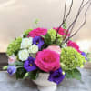 This arrangement has green hydrangea&rsquo;s, hot pink roses and purple lisianthus, white