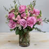 This arrangement is filled with vibrant roses, snap dragons and seasonal greens.