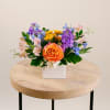 Brighten any room with Sunset Meadow, a fresh flower arrangement bursting with