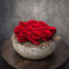 A timeless arrangement of preserved red roses set in a modern stone