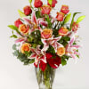 This blend of orange roses and pink stargazer lilies is the ideal