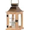 Wooden memorial lantern with metal top, glass panels, and candle inside.