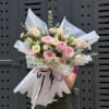 Soft pink roses and creamy tulips combine in a romantic birthday bouquet