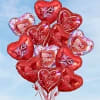 A playful cluster of shiny red heart-shaped balloons that say "I Love