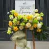 Bright yellow and soft cream roses cluster with round white and green