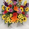 Brilliant color of lilies, sunflowers and roses in this funeral basket.