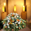A large, domed sympathy arrangement designed to offer comfort and quiet grace