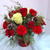 A lush cluster of red roses, creamy white roses, and bright red