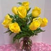 Bright lemon-yellow roses gathered in a clear glass vase make an instantly