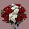 Arrangement of red roses and white mums in a blue vase with a white bow